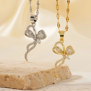 Micro-set zircon butterfly pendant necklace in gold and silver on silk background