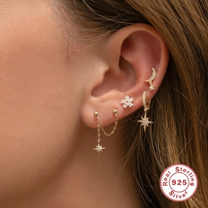 S925 sterling silver gold earrings set with star and moon charms worn by a model
