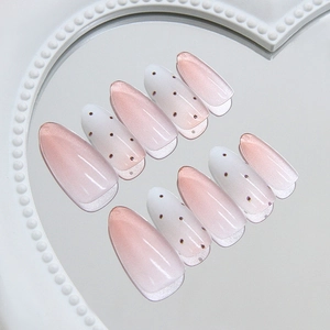 Pink cat eye gradient and burgundy polka dot press-on almond nails on a pearl mirror