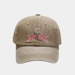 Close-up of vintage washed khaki cotton baseball cap with red New York embroidery