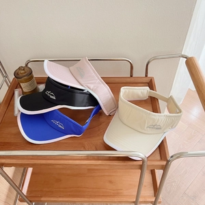 Detail of multi-colored running visors with FORTRAVEL embroidery on a display cart