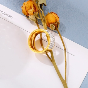 Macro view of wide 18k gold plated ring with triple rows of crystal pavé on blue backdrop