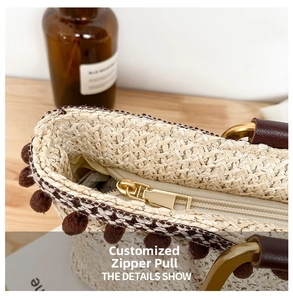 Macro detail of the golden custom zipper and woven texture on this stylish straw handbag