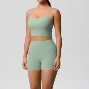 Detail of light mint green yoga set with thin straps and high-waisted fitness shorts