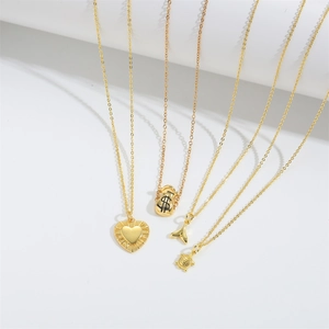 Gold money bag heart turtle and fish tail pendants on white elegant background