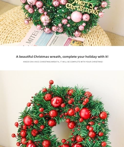 Detail of Christmas wreath featuring red berries and glossy pink ornaments on pine needles
