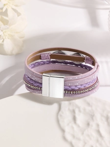 Close-up of bohemian multilayer purple leather bracelet with rhinestones and magnetic clasp
