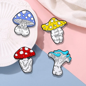 Detail view of four colorful mushroom enamel pins with creative and naughty shapes