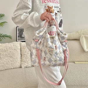Quilted crossbody canvas bag with teddy bear pattern and adjustable pink straps