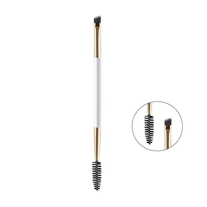 Close-up of dual-ended eyebrow brush with angled bristles and spiral mascara spoolie