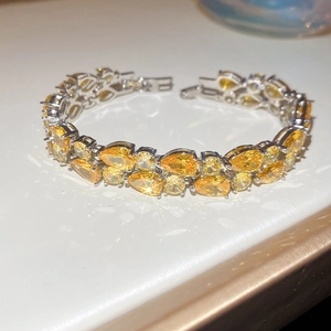 Close-up of double-row yellow pear-cut zircon bracelet with silver sparkling finish