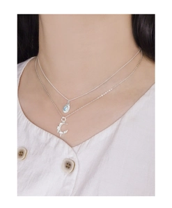 Double-layered S925 silver necklace featuring moon and sun pendants on female model