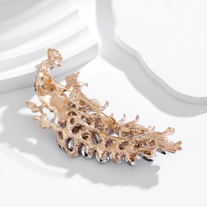 Luxurious peacock feather brooch with sparkling crystals on gold metal base