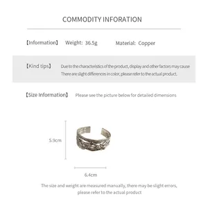 Detailed view of vintage copper bangle featuring brushed finish and butterfly floral patterns