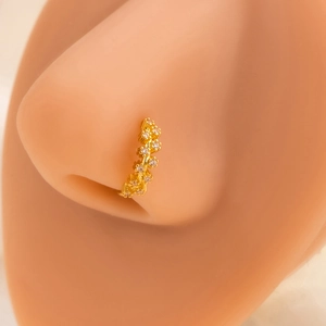 Golden flower leaf nose ring with small white zircons on a model for a refined look