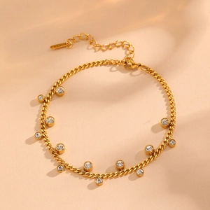 Detailed close-up of gold stainless steel anklet featuring sparkling zircon charms