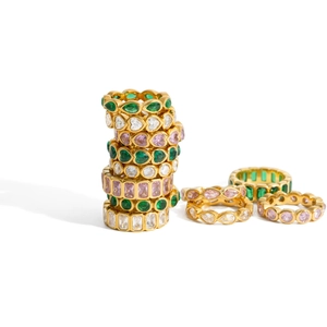 Classic gold stackable rings featuring colorful emerald and pink cubic zirconia gems