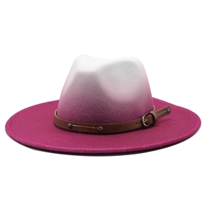 Detail of gradient fedora hat featuring a brown leather strap with metal studs and buckle