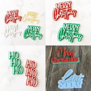 Various colorful acrylic Merry Christmas cake toppers with festive holiday phrases