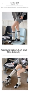 Detailed knit of white leg warmers with black stripes in Y2K aesthetic style
