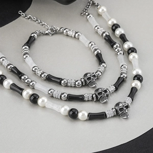 Chokers with black bamboo beads, white pearls, and a metal skull pendant for men and women