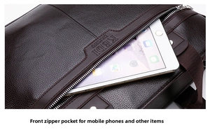 Detailed view of the front zipper pocket of a brown leather briefcase holding a tablet