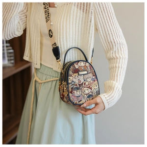 Detail of printed crossbody bag with teddy bear pattern and wide adjustable shoulder strap