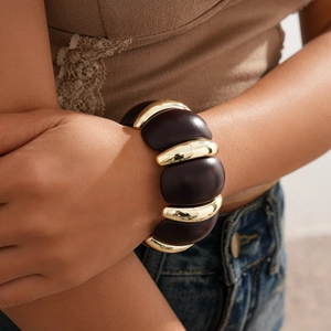 Detail of retro bohemian acrylic panel bracelet with gold and dark brown resin finish