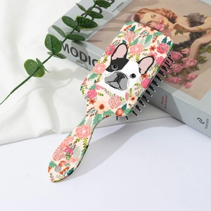 Detail of floral French Bulldog print hairbrush with flexible black massage bristles