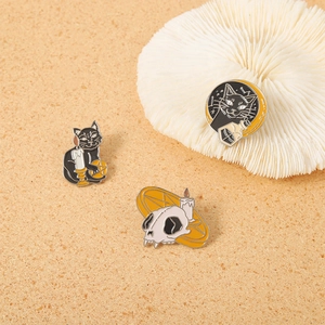Gothic Halloween pins set featuring black cat, skull and candles on a sand background