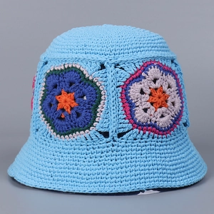 Detail of handmade crochet blue bucket hat with colorful floral granny square patterns
