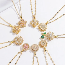 Macro shot of assorted flower pendant necklaces with colorful zircon stones and gold chains