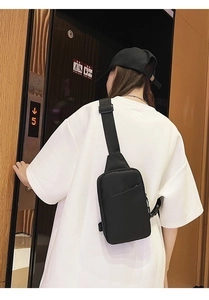 Detail of waterproof black nylon chest bag with adjustable shoulder strap for sports