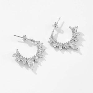 Elegant silver C-shaped earrings featuring micro-pave zircons and a pear-cut drop stone