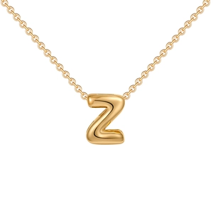 Macro shot of 18K gold-plated bubble letter Z pendant on a delicate cross chain