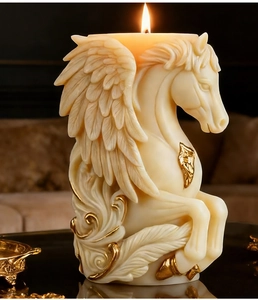 Detail of Pegasus candle featuring elegant hand-painted gold edges and soft warm flame