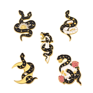 Gothic snake and skull enamel pin set with gold accents on white background