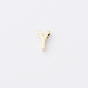 Close-up of golden stainless steel letter Y bead with polished mirror finish for DIY jewelry