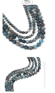 Macro detail of natural blue kyanite round beads showing translucent mineral texture