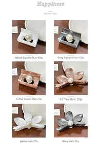 Detailed grid of vintage marble hair claws with central pearl accents on wooden surface