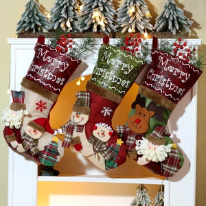 Three large Christmas stockings with 3D Santa and Reindeer hanging on a cozy fireplace