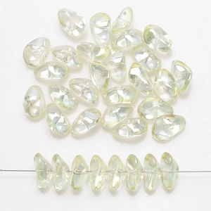 Macro view of iridescent petal-shaped glass beads showing pearlescent luster and texture