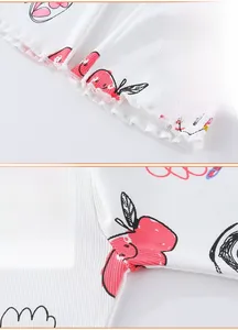 Detail of baby girls' ribbed knit flare pants featuring cute apple and rabbit patterns