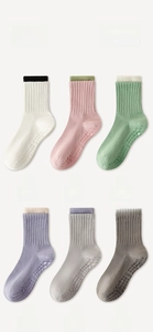 Detail view of anti-slip silicone grippers on six colors of cotton yoga socks
