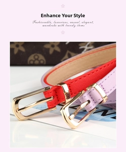 Detail of red and purple thin faux leather belts with golden buckles on a white table