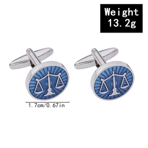 Close-up of silver Libra cufflinks with blue enamel finish for business shirts