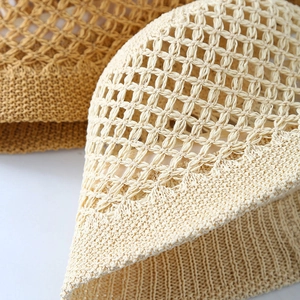 Close-up of lightweight hollow crochet weave on breathable straw sun hats in beige and yellow