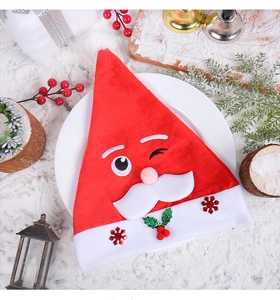 Detailed close-up of a festive plush Santa hat with holly and snowflake embroidery
