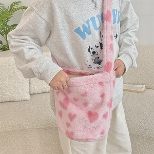 Pink heart-patterned plush bucket bag shown with a model for lifestyle scale