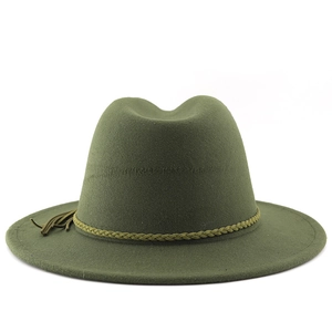 Detailed view of dark green wide brim fedora with woven band and decorative tassel